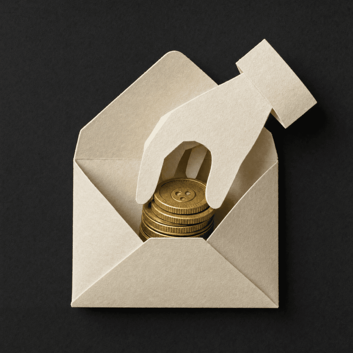 A hand collecting gold coins from a paper envelope